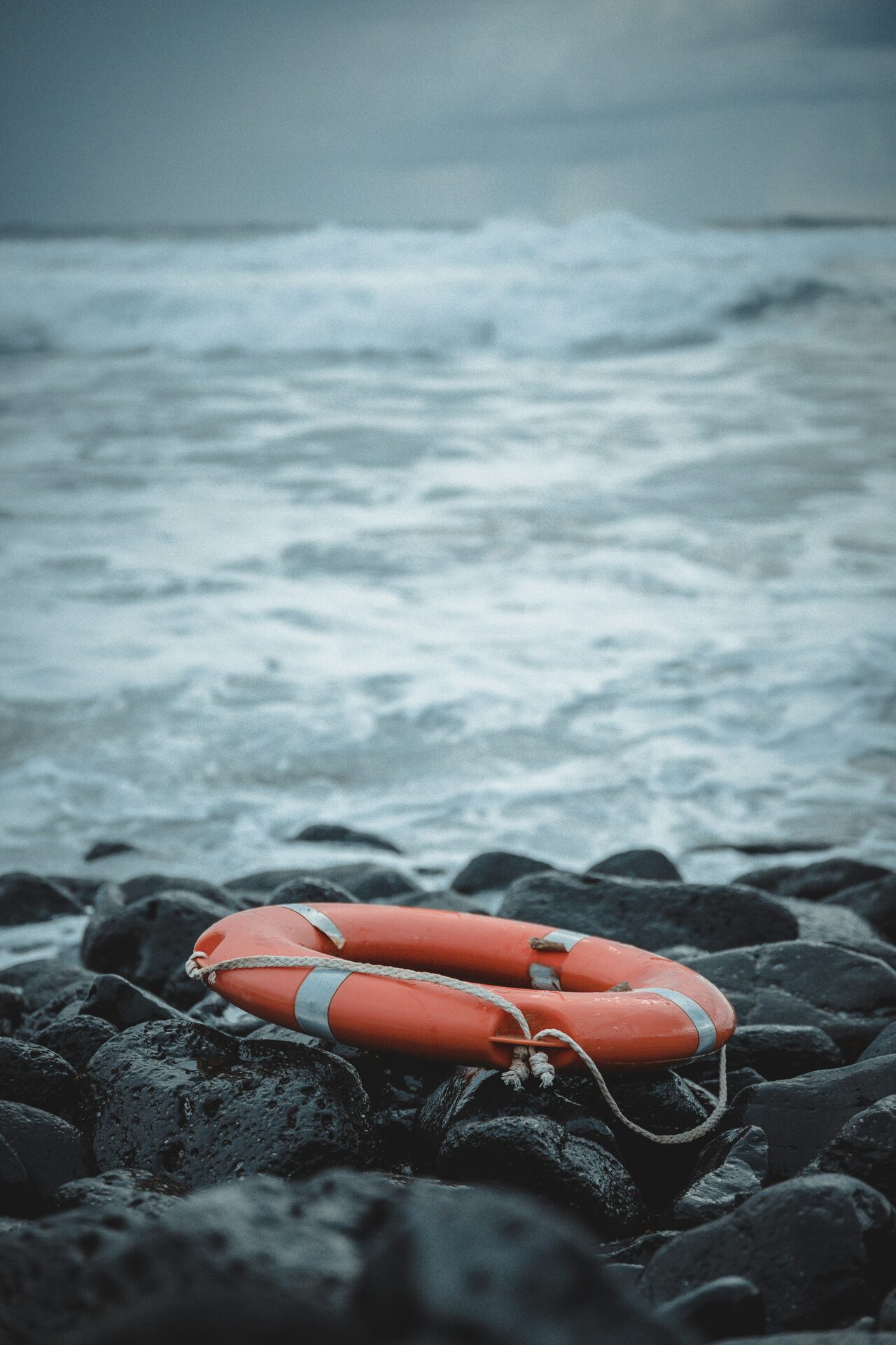 A lifebuoy on a storm coast, representing recovery before the evidence is lost.